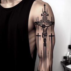 a man with a cross tattoo on his arm