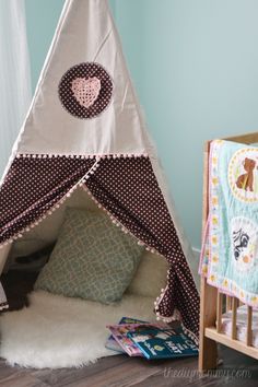 a child's teepee tent in the corner of a room