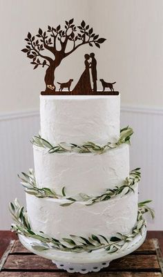 a wedding cake with a couple and dog on top