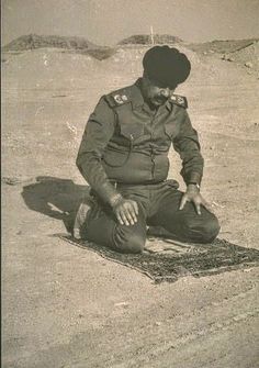 a man in uniform sitting on the ground