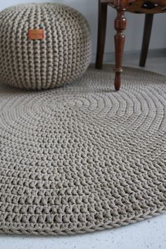 two crocheted bean bags sitting on top of a rug next to a chair