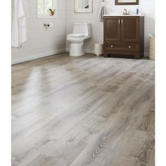 a bathroom with wood floors and white walls