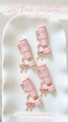 pink plastic cups and bows on a white plate