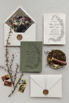 wedding stationery and envelopes laid out on top of each other