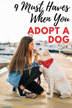 a woman sitting on the ground next to her dog with text overlay that reads, 9 must haves when you adopt a dog