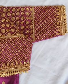 an embroidered purple and gold cloth with tassels