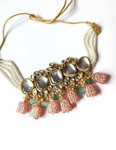 Studded with large sized kundan stones and handpainted glass danglers, this is a stunning choker. Comes with matching earrings. Color is peach. Dori/cord for adjustment! Choker width 2.63 inches Earrings length 2.90 inches Bohemian Kundan Necklace With Stone Work, Bollywood Kundan Jewelry With Dangling Beads, Festival Beaded Kundan Choker Necklace, Festive Beaded Kundan Choker Necklace, Diwali Kundan Beaded Choker, Bollywood Style Kundan Beaded Choker, Beaded Kundan Choker Necklace, Kundan Beaded Choker Necklace, Festive Kundan Beaded Choker