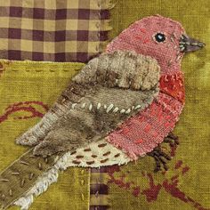 a close up of a bird on a piece of fabric