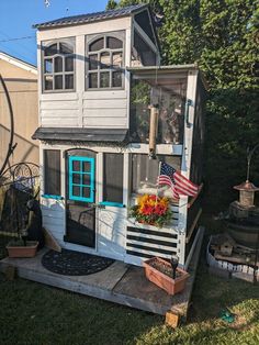 a small house with a flag on the porch