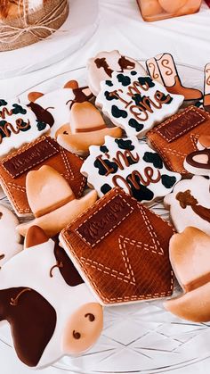 decorated cookies are arranged on a table with other items in the shape of horses and dogs