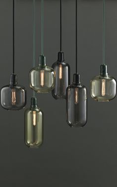 five glass pendant lights hanging from the ceiling