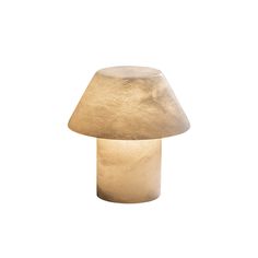 a mushroom shaped light sitting on top of a white wall