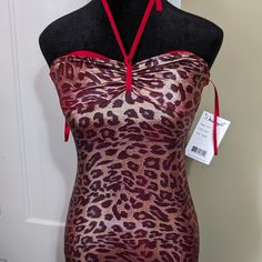 a mannequin wearing a red and black dress with a leopard print pattern on it