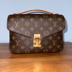 Louis Vuitton Pochette Mtis. Pristine Condition, Comes With Dust Bag And Original Orange Case. With Receipt Luxury Monogram Canvas Flap Bag For Formal Occasions, Luxury Formal Monogram Canvas Flap Bag, Luxury Monogram Canvas Flap Bag, Elegant Monogram Canvas Flap Bag With Gold-tone Hardware, Designer Envelope Bag With Gold-tone Hardware, Designer Envelope Bags With Gold-tone Hardware, Luxury Envelope Shoulder Bag With Gold-tone Hardware, Pochette Louis Vuitton, Louis Vuitton Multi Pochette