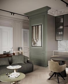 a living room filled with furniture next to a kitchen