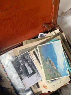 an open suitcase filled with pictures and papers