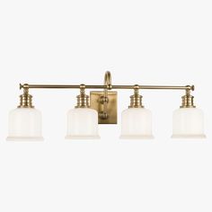 three light brass bathroom fixture with white glass shades