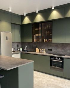 a kitchen with green cabinets and an island