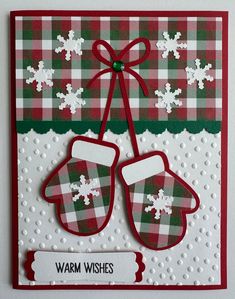 a handmade christmas card with two mittens on it, and the words warm wishes