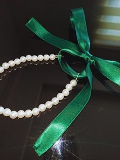 Our pearl necklace with laces reflecting the nobility of green is completely handmade and specially designed for you. It is made of 26 8 mm pearls in total and has a 40 cm bright green ribbon on both sides. With this ribbon, you can adjust it to your liking and use it with pleasure. If you want, we can extend the amount of pearls and ribbon length. You can specify it in the customization section. pearls are not real Green Pearl Necklace For Gift, White Ribbon Necklace For Gift, Elegant Green Pearl Necklace For Gift, Green Pearl Necklace For Party, Elegant Pearl Necklaces With Ribbon, Elegant Pearl Necklace With Ribbon, Pearl Ribbon, Lace Necklace, Ribbon Necklace