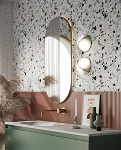 a bathroom with a sink, mirror and plants on the counter top in front of it