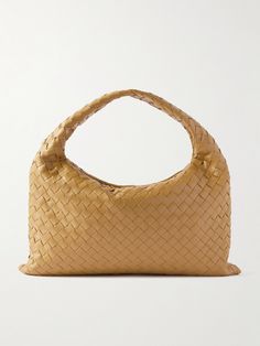 Bottega Veneta's tote perfectly showcases the label's fine craftsmanship. Made from strips of supple leather, it's woven using the house's signature intrecciato technique - the result is a streamlined shape that slightly slouches in the middle. The top handle elegantly arches, so it'll sit neatly in the crook of your arm. Secure your smaller valuables in the zipped pocket inside, using the main compartment to stow your wallet, sunglasses and water bottle. Designer Tote Shoulder Bag With Interwoven Design, Designer Bags With Interwoven Design For Shopping, Luxury Shoulder Bag With Interwoven Design And Double Handle, Luxury Shoulder Bag With Double Handle And Interwoven Design, Designer Shoulder Bag With Interwoven Design For Shopping, Luxury Bags With Interwoven Design And Double Handle, Beige Leather Bags With Interwoven Design, Classic Bags With Interwoven Design For Everyday Use, Luxury Brown Shoulder Bag With Interwoven Design