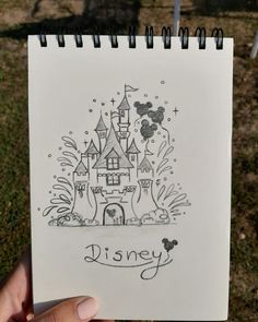 someone is holding up a disney castle drawing