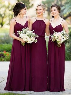 three bridesmaids in purple dresses standing together