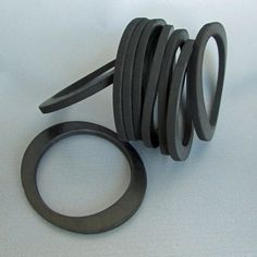 an assortment of black rubber rings and washers