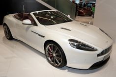 a white sports car on display in a showroom