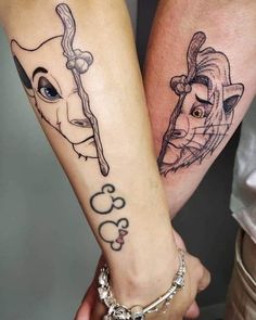 two people are holding hands with tattoos on their arms, one has a cow and the other has a man's face