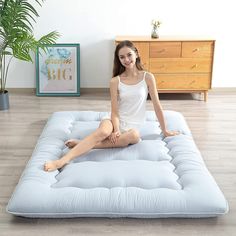 a woman is sitting on an inflatable mattress