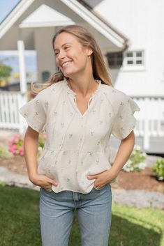 Fiona Top - Cream – Neuflora Flowy Tie Neck Top For Summer, Feminine Peplum Blouse For Brunch, Feminine Spring Top With Ruffled Collar, Chic Flutter Sleeve Tops For Daywear, Casual Ruffled Collar Blouse For Brunch, Feminine Ruffled Peplum Top, Chic Short Sleeve Peasant Top For Spring, Feminine Summer Peasant Top With Ruffles, Chic Ruffled Peasant Top For Daywear