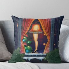 a christmas scene with a woman standing in front of a window holding a lamp throw pillow