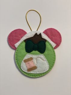 a mickey mouse ornament hanging on a wall