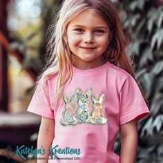 Watercolor Bunny Trio - Youth Short Sleeve Tee This Super Cute Tee is perfect for Easter or Spring.  It's printed in a soft print with vibrant colors.  Our shirts are super soft and light weight.  These are available in several beautiful colors. **Colors Shown in Sample:  Pink - 4.2 oz., 52/48 Polyester / Airlume Combed and Ringspun Cotton - Shoulder to Shoulder Taping - Unisex fit, side seams - Tearaway Label - Youth Sizes:  S - XL (Bella Canvas) - Printed with Soft DTF Prints **Please see sizing chart in our Photo Gallery **Also available in adult sizes.  See seperate listing. Cute Easter T-shirt With Short Sleeves, Pink Cotton T-shirt For Easter, Playful Easter Short Sleeve T-shirt, Cheap Short Sleeve T-shirt With Bunny Print, Cheap Bunny Print Short Sleeve T-shirt, Kids Graphic Tees, Color Show, Beautiful Colors, Kids Tshirts