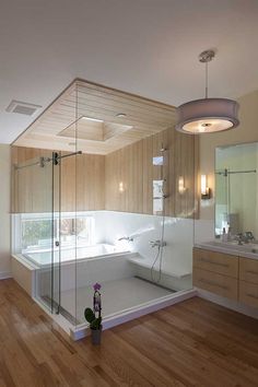 a large bathroom with wooden floors and walls