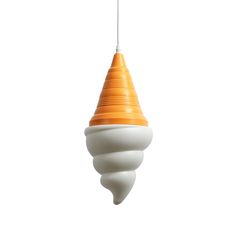 an orange and white light hanging from a ceiling fixture in the shape of a cone