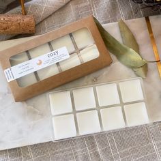 a box of wax next to a knife and other items on a tableclothed surface