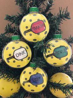 a christmas tree made out of yellow and black polka dot ornaments with words on them