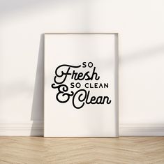 a black and white poster that says so fresh, so clean on the wall next to a wooden floor