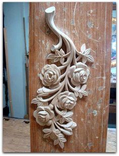 an intricately carved wooden door handle with flowers on it