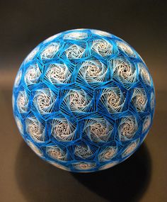 a blue and white ball sitting on top of a table