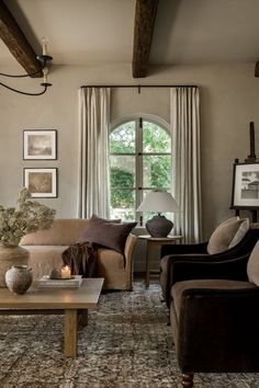 a living room with two couches and a coffee table in front of a window