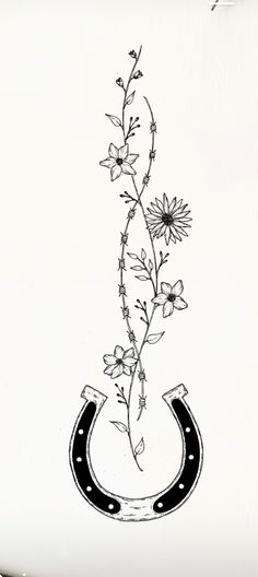 a black and white drawing of a flower in a horseshoe