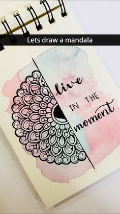 a spiral notebook with the words live in the moment written on it