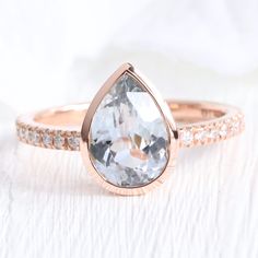 an engagement ring with a pear shaped diamond in the center