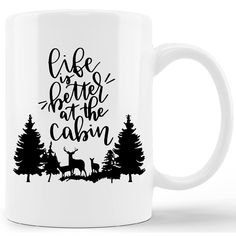 a white coffee mug with the words life is better at the cabin on it