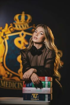 a woman sitting in front of some books