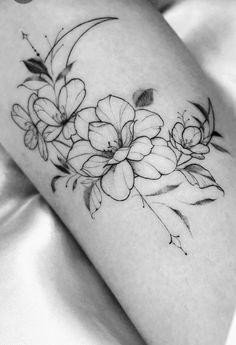 a black and white photo of flowers on the arm